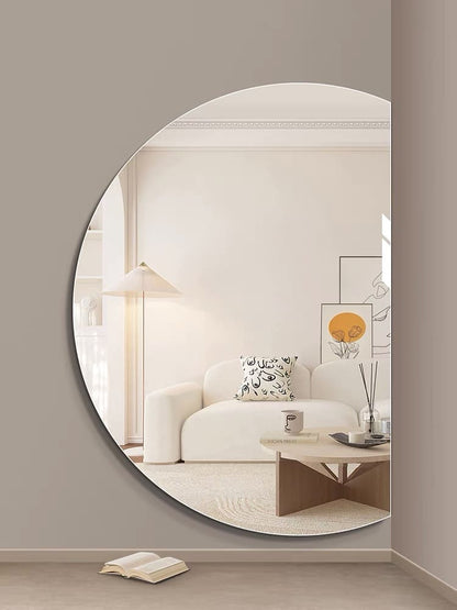 Half moon frameless wall mirror styled in living room