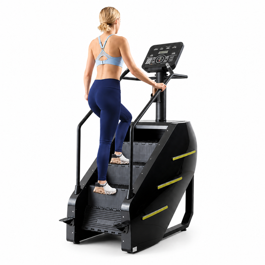 Woman climbing the black Hubsite stair climber with LED console, handrails and yellow-green side strips, on white
